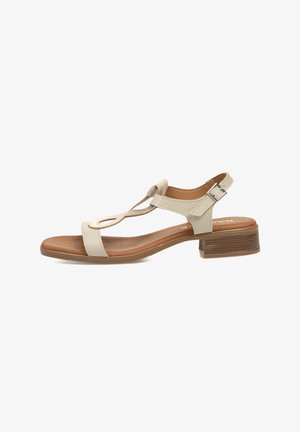 Sándalo beige con un diseño de tira en T, parte superior texturizada, correa ajustable en el tobillo y un tacón bajo en bloque. Plantilla suave con un acabado natural.