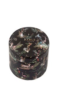 Round storage box with a black background, featuring floral and animal patterns in vibrant colors. Gold "FABLE ENGLAND" logo on the lid.