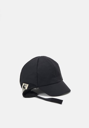 Svart caps laget av myk, teksturert stoff, med en buet skygge, øreflapper og et logomerke på siden. Inkluderer en justerbar stropp.