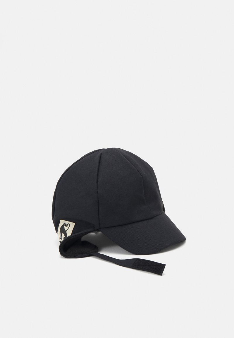 Black cap made of soft, textured fabric, featuring a curved brim, ear flaps, and a logo patch on the side. Includes an adjustable strap.