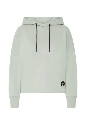 Hellgraue, kurz geschnittene Kapuzenjacke aus weichem Stoff. Mit schwarzem Kordelzug, überschnittenen Schultern und einem runden schwarzen Logopatch an der Seite.