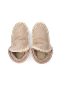 Pantofole in suede beige con una morbida fodera interna, design a punta rotonda e bordi cuciti. Presentano un aspetto testurizzato e accogliente, adatto per l'uso interno.