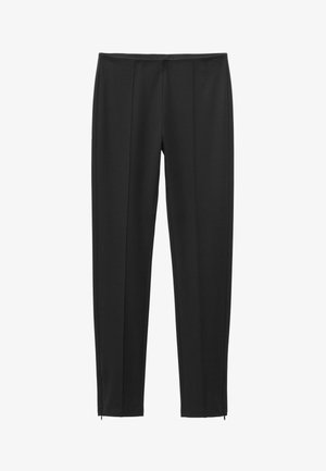 Pantalon noir ajusté avec coutures verticales et petites fermetures éclair au bas de chaque jambe.