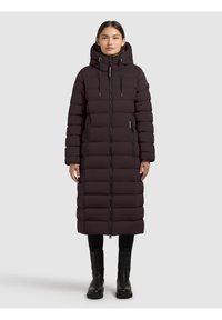 Long, dark purple puffer coat with a hood, featuring a front zipper and side pockets. Textured, quilted design enhances insulation. Black accents.