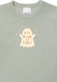 Grüner Baumwollstrampler mit einem Geisterdesign und dem Text "TRICK OR TREAT" sowie bunten Sternenakzenten; mit Druckknopfverschlüssen an den Schultern.