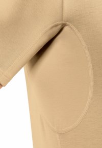 Beige short-sleeve shirt featuring a smooth texture, curved stitching details, and a drop shoulder design for a relaxed fit.