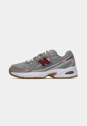 Gray athletic shoe with mesh and synthetic material, red accents, and a white midsole featuring "ABZORB" branding. Designed for comfort and support.