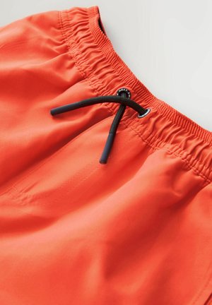 Orangefarbene Badehose mit elastischem Bund, schwarzem Kordelzug und glattem Stoff. Verfügt über Nahtdetails und eine Seitentasche.