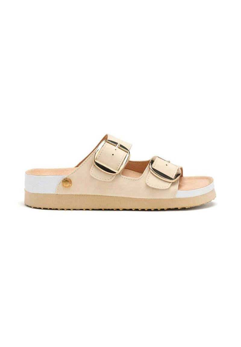 Sandalia deslizante beige con dos hebillas ajustables, material suave, suela texturizada y franja blanca de acento en la suela.