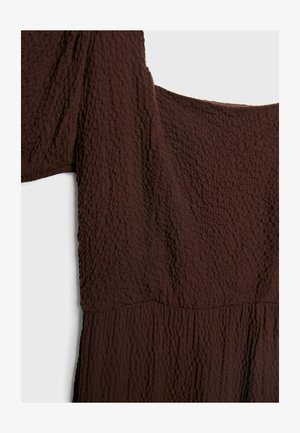 Brown textured fabric dress featuring a square neckline and short sleeves, with a crinkled pattern throughout. No visible hardware.