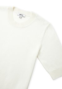 Maglione di colore chiaro in maglia, con scollatura rotonda e maniche corte, caratterizzato da una superficie liscia e dettagli di cucitura minimi.