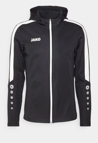 Zwarte zip-up jas met capuchon, witte zijstreepjes, grijskleurige knopenaccenten op de mouwen en het "JAKO"-logo op de borst, gemaakt van een zachte stof.