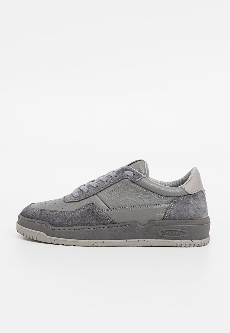 Gray low-top sneaker with suede and leather panels, lace-up closure, perforated toe, and a branded sole.