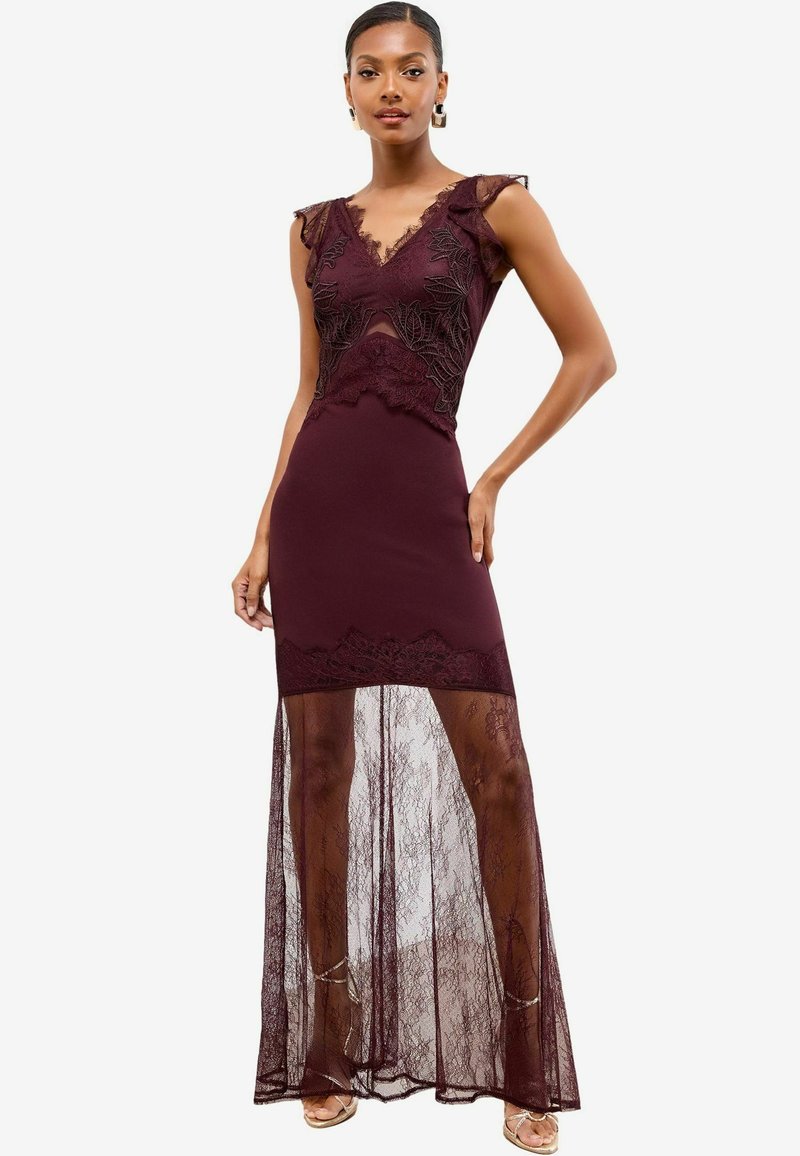 Burgunderfarbenes Kleid mit einem taillierten Spitzenoberteil, durchscheinendem Spitzenrocküberzug und rüschigen Spitzen-Schulterakzenten. Satinähnliche Textur und filigrane Details.