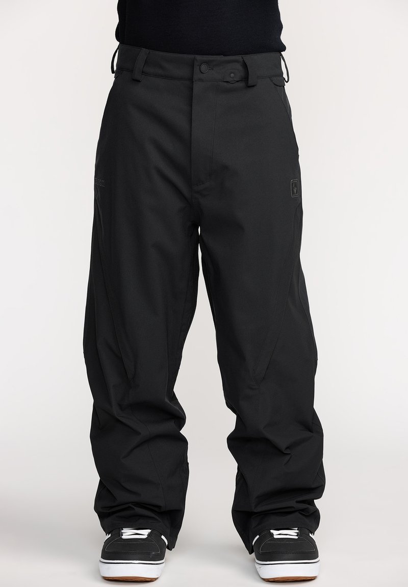 Pantalons de neige noirs imperméables à coupe ample, dotés d'une fermeture à bouton, de poches latérales et d'un tissu texturé pour plus de durabilité.