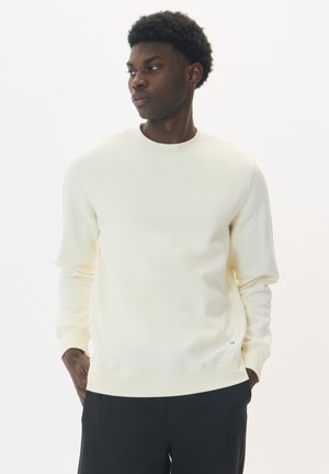 Crèmekleurige sweatshirt van zacht materiaal, met een ronde hals, lange mouwen en ribgebreide manchetten, voorzien van een klein logo op de zoom.