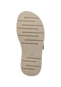 Beige rubber shoe sole with textured surface and horizontal grooves for grip. Includes a circular logo and size marking.