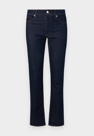 Jeans in denim con un lavaggio blu scuro, design a gamba dritta, cinque tasche e cuciture a contrasto. Caratterizzati da una chiusura frontale con bottone.