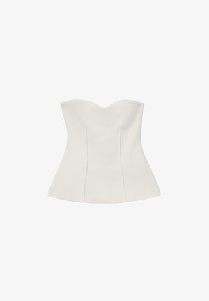 Corset blanc sans bretelles avec décolleté en cœur et silhouette ajustée évasée.