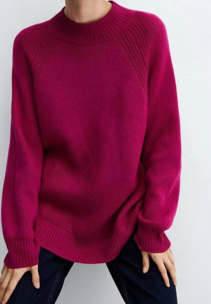 Fuchsia knit sweater with a ribbed crew neckline, dropped shoulders, and long sleeves, featuring a relaxed fit and textured fabric.