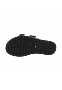 Zwarte sandaalzool met een gestructureerd grippatroon, voorzien van twee verstelbare banden. Duurzaam rubbermateriaal met een lichte kromming bij de teen.