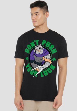 Black cotton t-shirt featuring a graphic design of an armored character and text "DON'T PUSH YOUR LUCK" in green and purple.