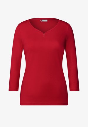 Rode lange mouwen shirt van zachte stof, met een V-hals en twee knoopaccenten. Glad textuur met een ontspannen pasvorm.