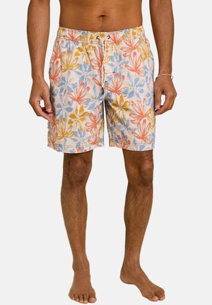 Buste et jambes d'un homme portant un short de bain beige avec un motif floral orange, bleu et jaune, une ceinture élastique et un cordon de serrage à l'avant.