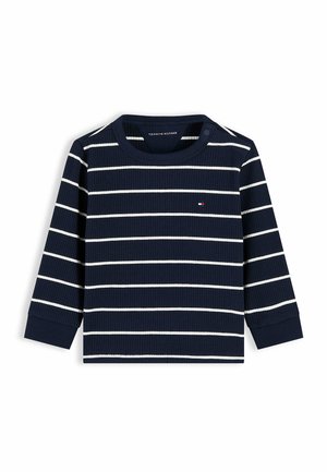 Marineblaue langärmelige gerippte Bluse mit weißen horizontalen Streifen und einem kleinen rot-weiß-blauen Logo auf der Brust.