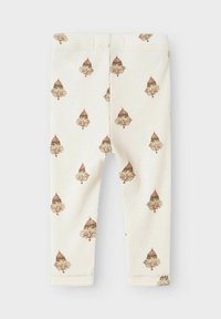 Jasne, kremowe legginsy z powtarzającym się wzorem brązowych i różowych żołędzi; miękka, żebrowana tkanina z przeszytymi brzegami.