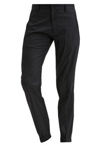 Pantalones negros hechos de tela suave, con un diseño ajustado, piernas ajustadas y puños elásticos en los tobillos. Sin bolsillos visibles.