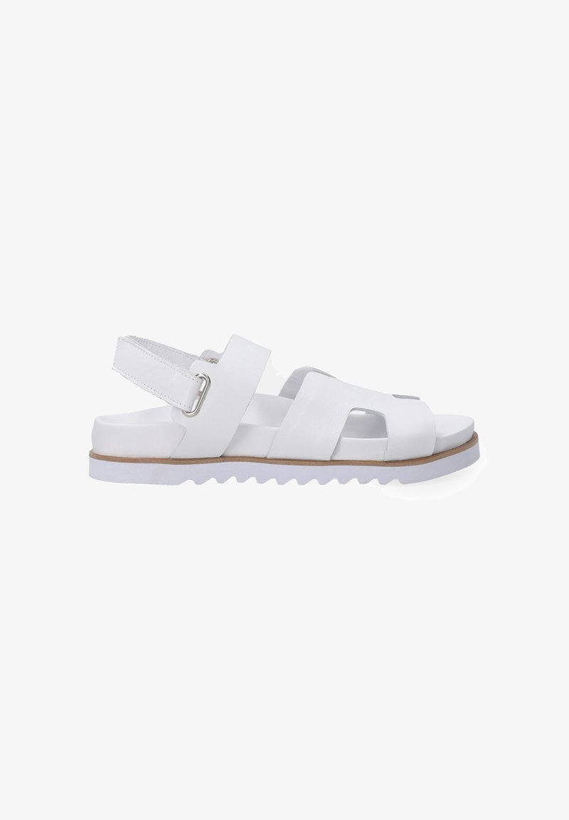 White sandal featuring a textured leather upper, open-toe design, adjustable ankle strap, and a ridged rubber sole. Smooth finish.
