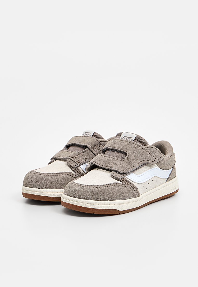 Graue Wildledersneaker mit weißen Akzenten, ausgestattet mit Klettverschlüssen und einer Gummisohle. Das Design beinhaltet eine klassische Silhouette und Nähdetails.