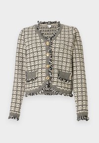 Tkaný černo-bílý kardigan s houndstooth vzorem, třepenými okraji, zlatými knoflíky a dvěma předními kapsami. Krátký, přiléhavý střih.