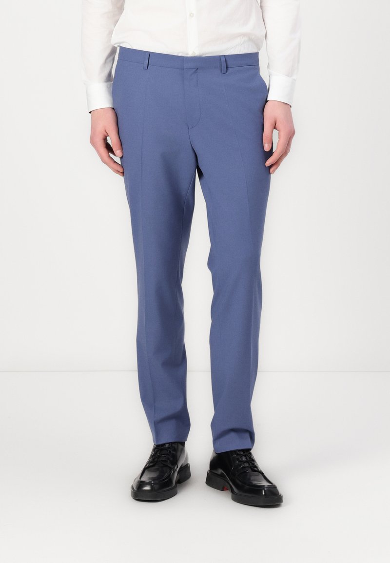 Tailored blue trousers made from fabric with a smooth texture. Features a flat front, side pockets, and a slim fit design.
