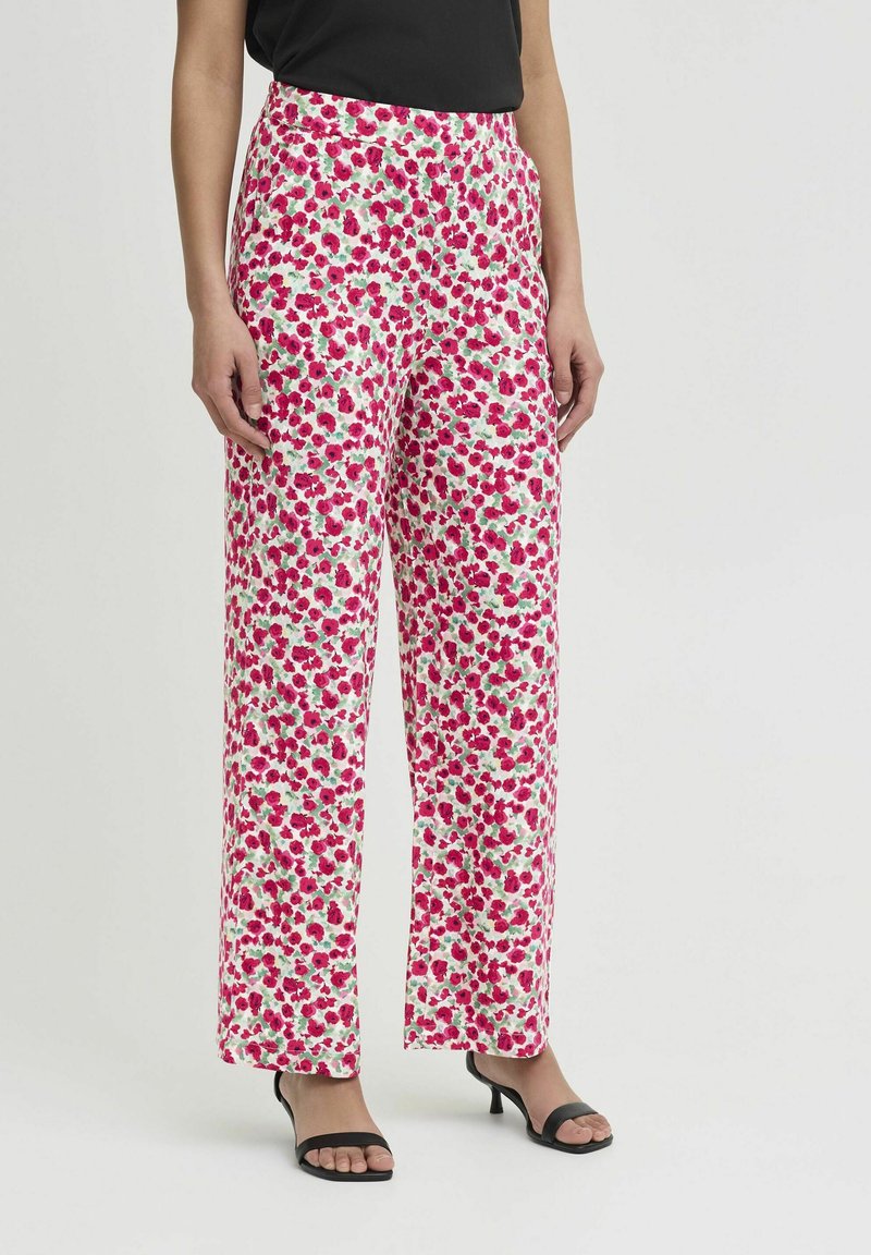 Wijdvallende broek met bloemenprint in het wit, met roze en groene tinten. Gemaakt van lichte stof met een elastische taille en zijzakken.