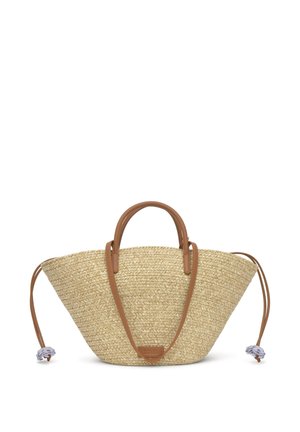 Bolso tote de paja con cuerpo ancho en forma de abanico, asas de cuero marrón claro, una correa larga y cordones decorativos con charms de flores moradas.