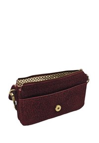 Sac bandoulière à imprimé léopard rouge avec une fermeture éclair dorée, une poche plate à l'avant et un fermoir à pression doré. Tissu texturé avec une finition douce.