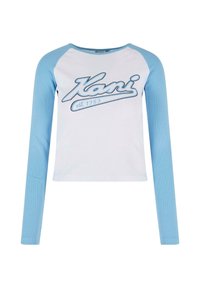 Valkoinen pitkähihainen paita, jossa vaaleansiniset raglan-hihat. Rintamuksessa on sininen graafinen "Kani est. 1989" -logo. Ribboitu pinta.