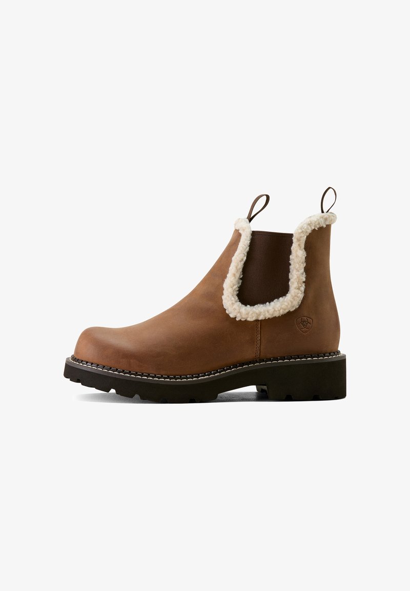 Braune Lederstiefelette mit einem Kunstfellbund, runder Zehenpartie, Ziehlaschen und einer strukturierten Gummisohle mit kontrastierenden Nähten.