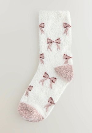 Harmaa valkoinen sukka, jossa on vaaleanpunaisia nauhakuviota ja yhdenmukainen vaaleanpunainen karvainen kärki. Pehmeä rakenne ja ribbausvarsi mukavan istuvuuden saavuttamiseksi.