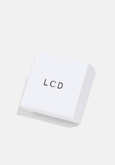 White rectangular box with a smooth texture, featuring the printed black text "LCD" on the top surface.