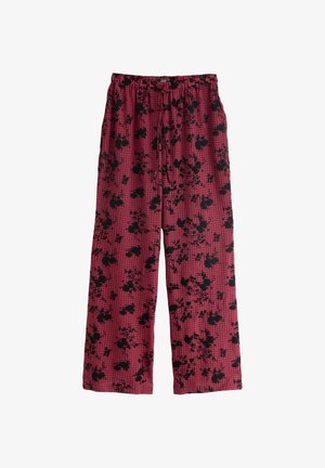 Pantaloni în carouri roșii cu un model floral negru, prevăzuți cu talie elastică și croială cu picioare largi, realizați dintr-un material ușor.