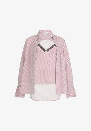 Striped button-up shirt in red and white with long sleeves, featuring a cropped layer underneath in a coordinating pattern and a sleek neckline.