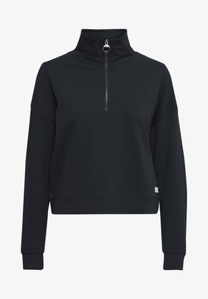 Black pullover with a high collar and half zip, made of soft fabric. Features a cropped design and ribbed cuffs. Minimal branding on the hem.