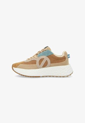 Brown and beige corduroy sneaker with a blue accent, circular cutout detail, white cushioned sole, and textured grip outsole.
