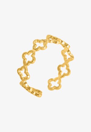 Bague en or avec des motifs de trèfle découpés, dotée d'une finition texturée. Chaque maillon possède un bord lisse, créant un design délicat et ouvert.