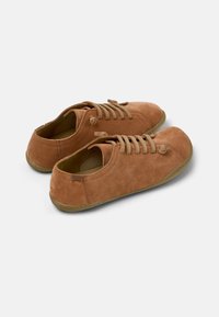 Brown suede casual shoes with round toe, lace-up design, beige laces, and rubber soles; smooth texture, minimal accents.