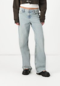 Light blue jeans made from denim, featuring a relaxed fit, straight leg design, and classic five-pocket style with subtle fading.