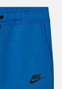 Nike Sportswear TECH FLEECE PANT - Treniņtērpa apakšdaļas - light photo blue/black
